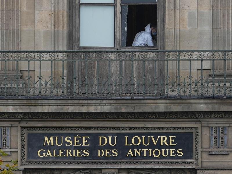 Brazen thieves used a crane to break a window when they robbed jewelry from the Louvre in Paris. (AP PHOTO)