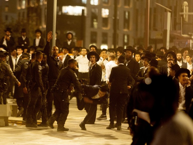 Thousands of Ultra-Orthodox Jewish men hold a massive anti-draft rally.
