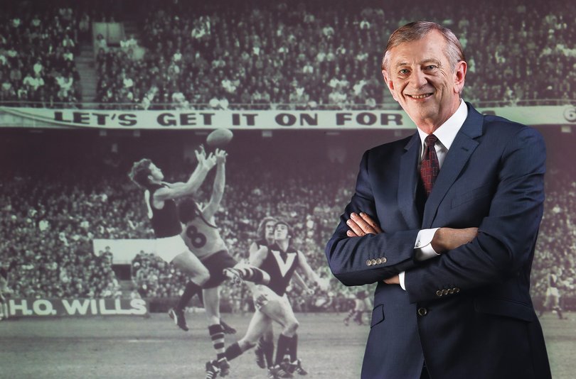 Dennis Cometti in front of a projected image from the very first game he commentated.