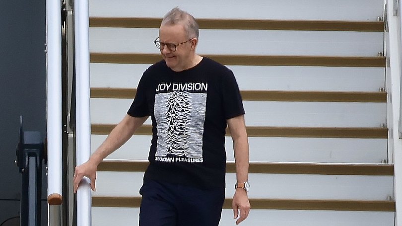 Mr Albanese in a Joy Division tee after he disembarked at Sydney Airport last week.