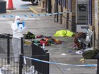 A forensic investigator films the area where travellers left their belongings at Huntingdon Station after a mass stabbing on a London-bound train. (Joe Giddens/PA via AP)