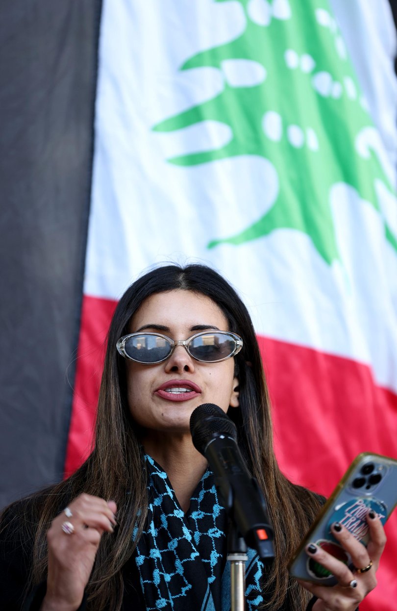 Former Greens candidate Hannah Thomas was allegedly assaulted by a police officer during a protest outside a weapons-plating corporation.