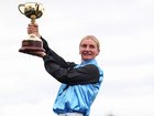 Jamie Melham with the 2025 Lexus Melbourne Cup after riding Half Yours to win.