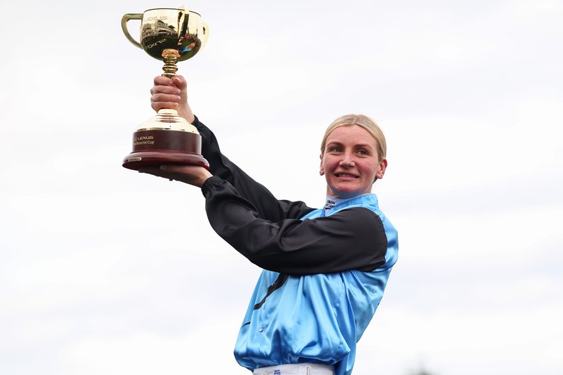 Jamie Melham kisses the 2025 Lexus Melbourne Cup after riding Half Yours to win race seven the Lexus Melbourne Cup.