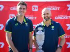 Australian cricketers Pat Cummins and Nathan Lyon pose for a photo with the Ashes trophy.