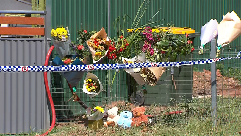 Floral tributes at the scene of the Emerald house fire, which claimed four lives.