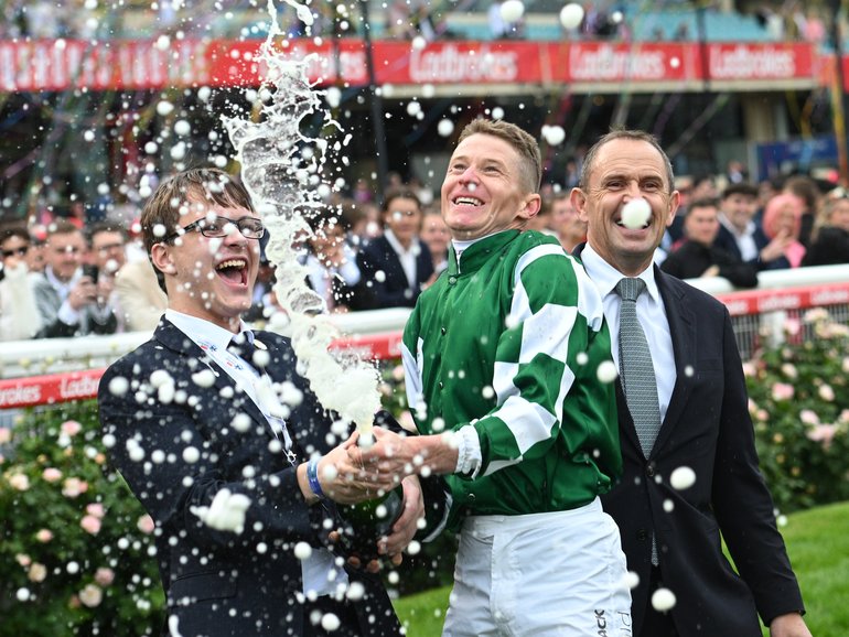 James McDonald sprays champagne after riding Via Sistina to win Race 10.