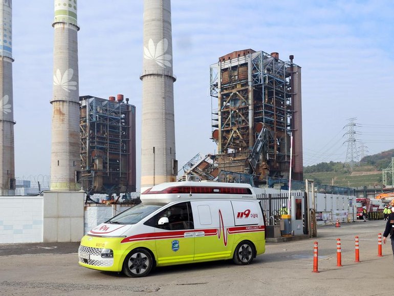 At least three people are dead after a 60 metre high tower collapsed at a South Korean power plant. (AP PHOTO)