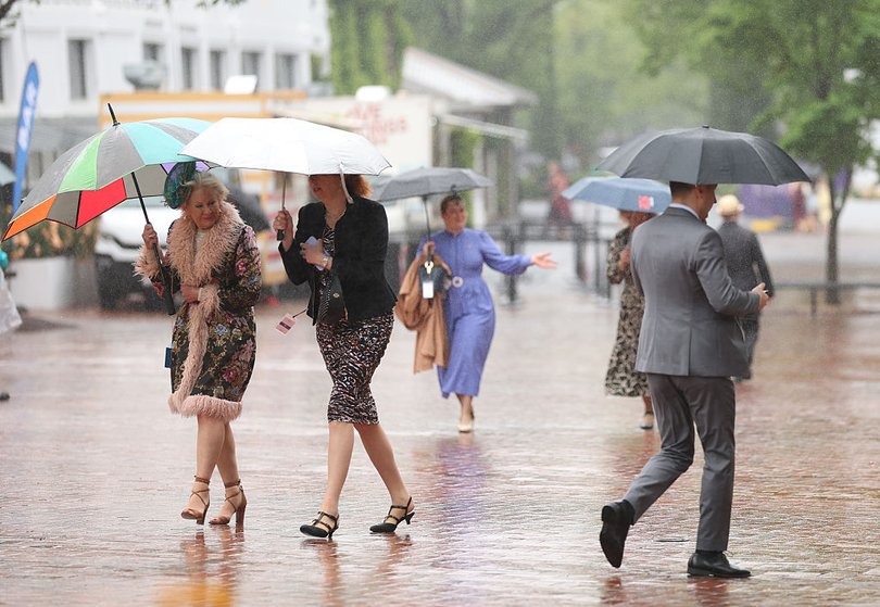 Spectators arrive on a cold and miserable day.
