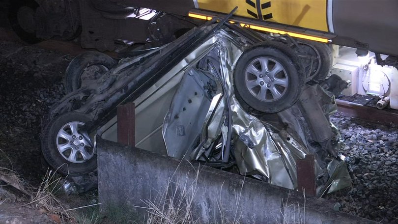 A woman has made a lucky escape after her car was hit by a train and crushed south of Brisbane. 