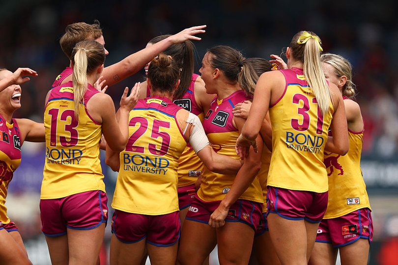 Brisbane players celebrate during their strong win over Melbourne.