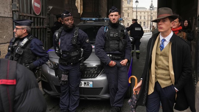 Pedro Elias Garzon Delvaux walked past police outside the Louvre after the Paris museum was robbed. (AP PHOTO)