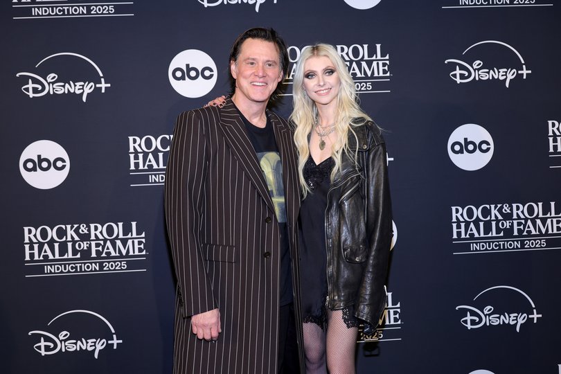 Jim Carrey and Taylor Momsen pose in the press room during the 2025 Rock & Roll Hall of Fame Induction Ceremony at Peacock Theatre.