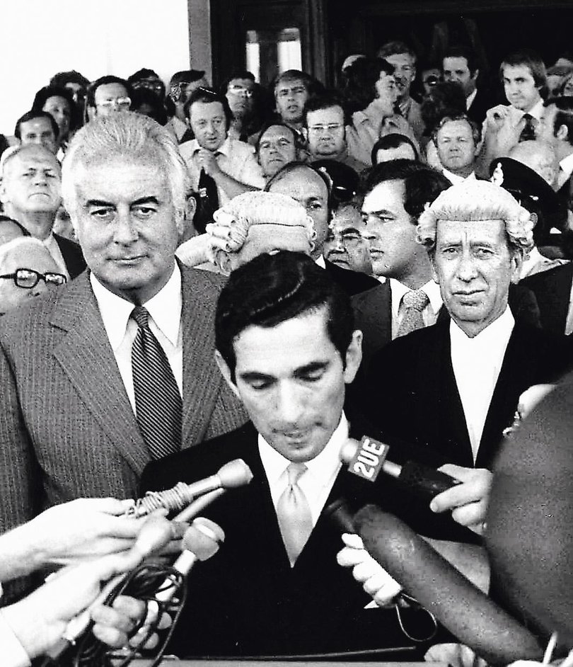 Sacked Prime Minister Gough Whitlam listens to David Smith read the proclamation dissolving Parliament.