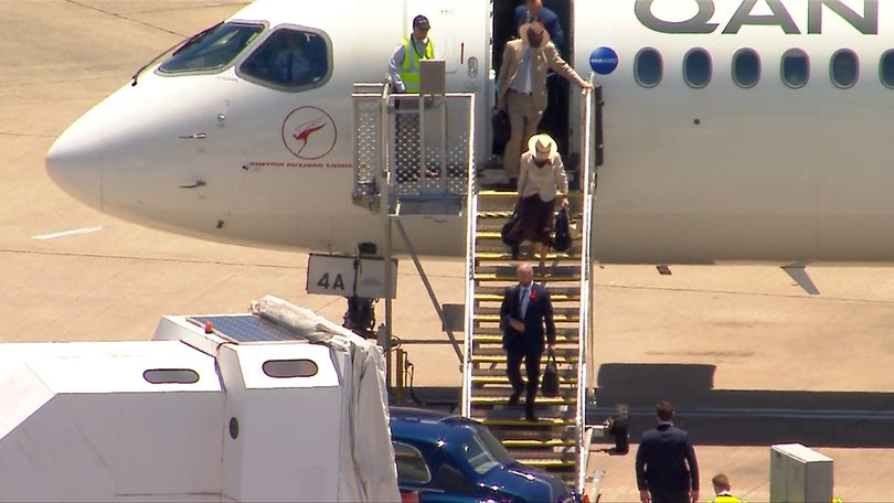 Princess Anne disembarks the Qantas aircraft, greeted by officials on the ground.