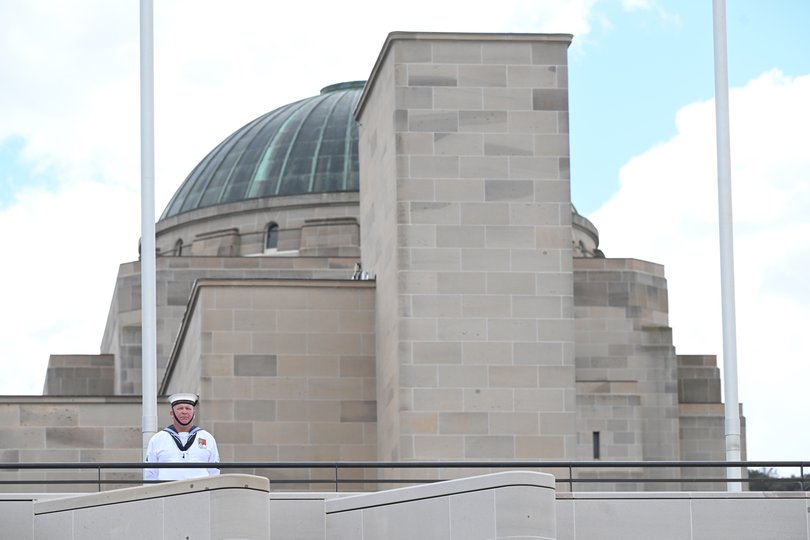 A member to the Australian Defence Force stands in front of the Australian War Memorial during a Remembrance Day service at the Australian War Memorial, in Canberra.