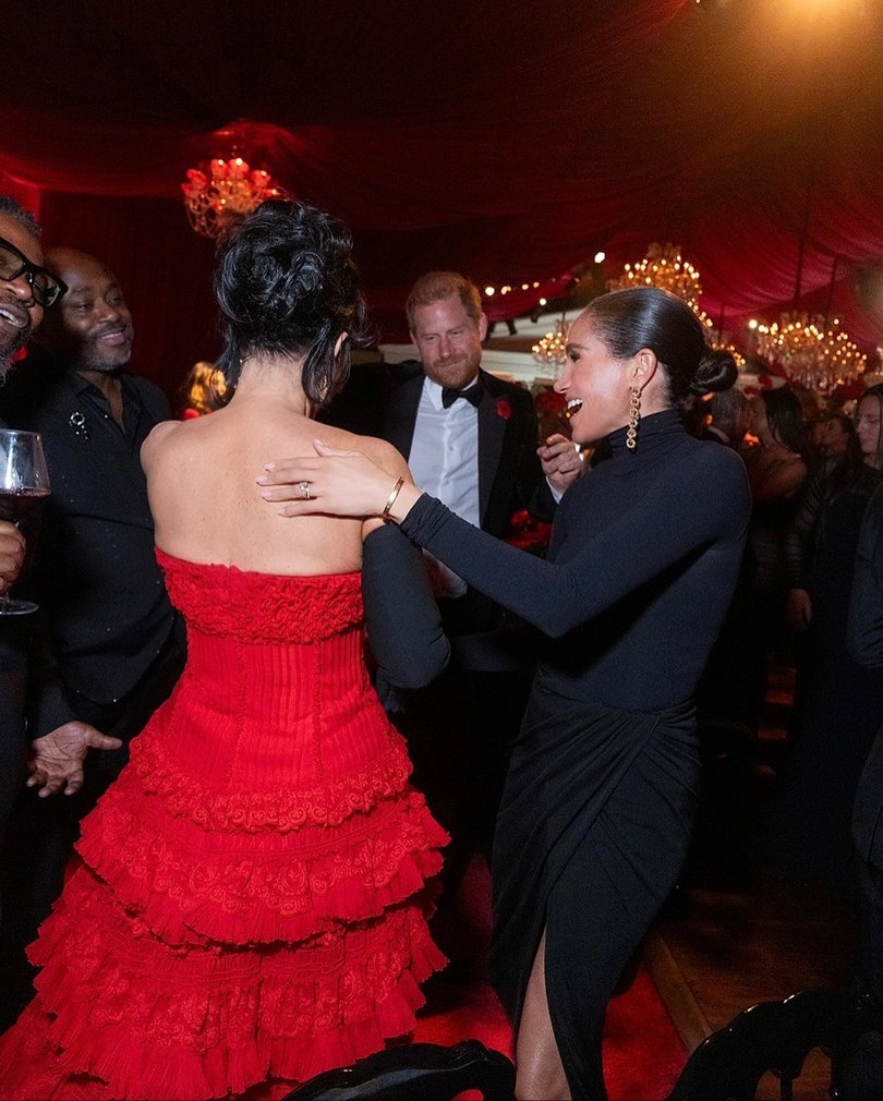 Kris Jenner dances with Prince Harry and Meghan Markle.