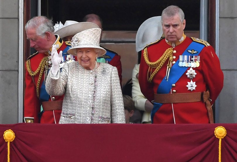 Queen Elizabeth II and Prince Andrew stand on the balcony of Buckingham Palace.