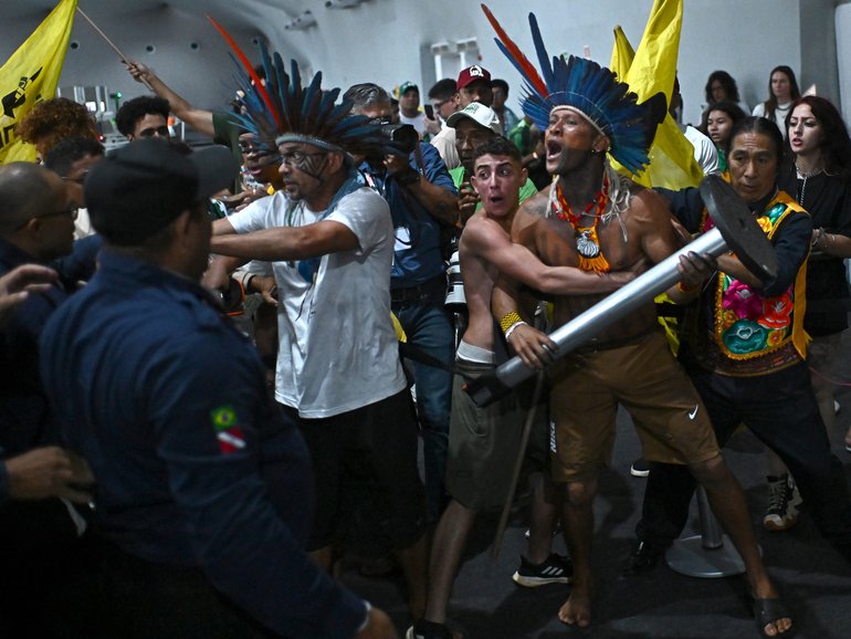 Protesters clash with security forces in an attempt to storm the COP30 headquarters in Belem, Brazil.