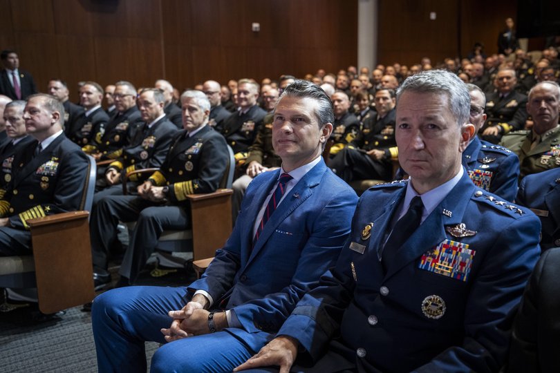 Secretary of Defence Pete Hegseth, centre, watches as President Donald Trump delivers remarks to military leadership in Quantico, Va., Sept. 30, 2025.