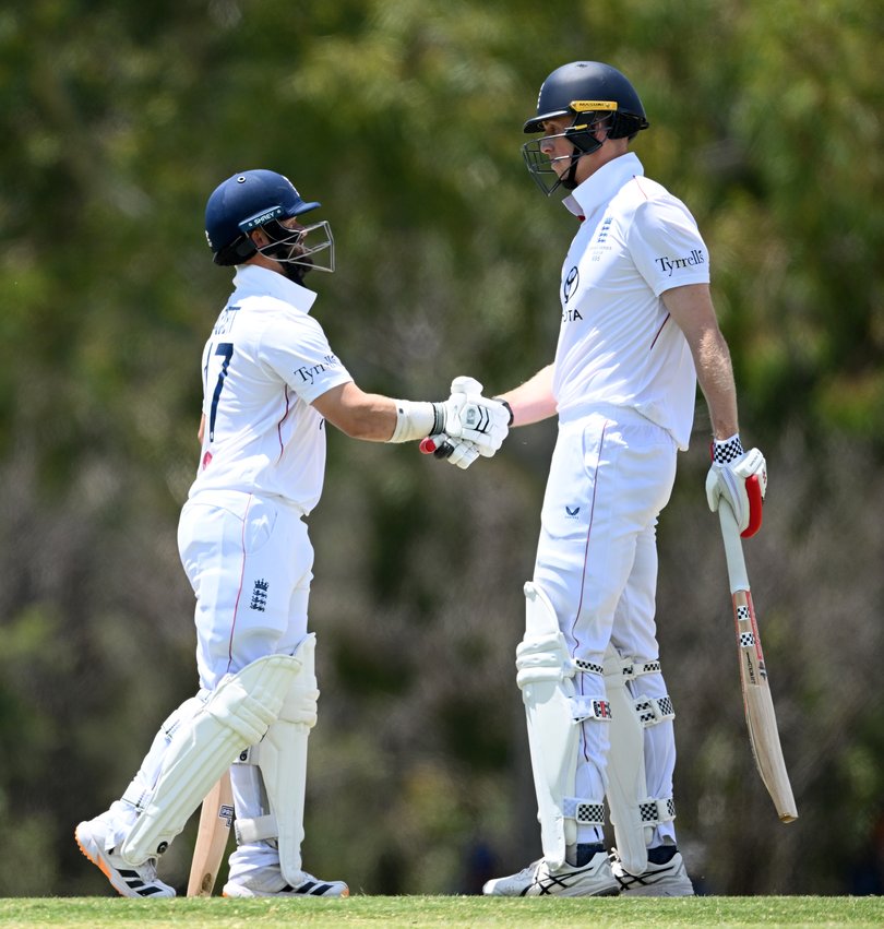 Ben Duckett and Zak Crawley of England shake hands.