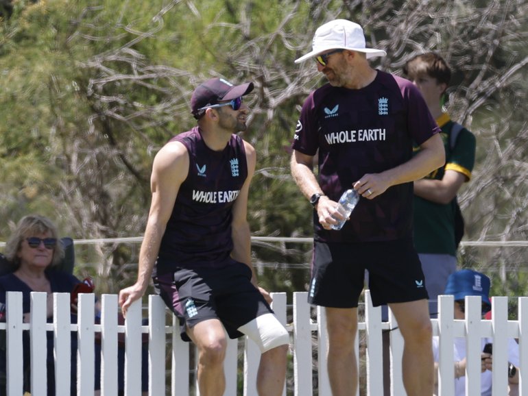 Mark Wood (2nd from right) for England watches from the boundary at Lillac Hill.