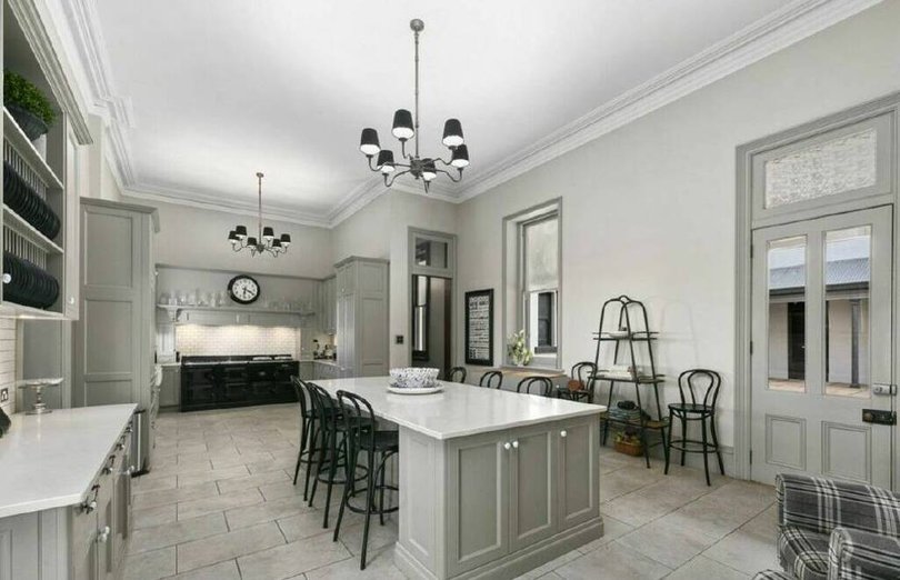 The kitchen has an open fireplace and a walk-in cool-room.