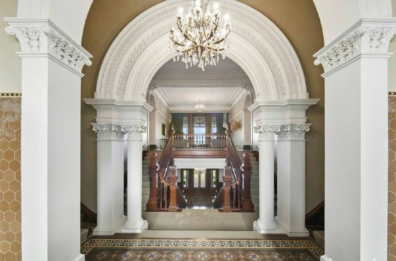 The opulent home showcases the architectural style of the Victorian Italianate era.