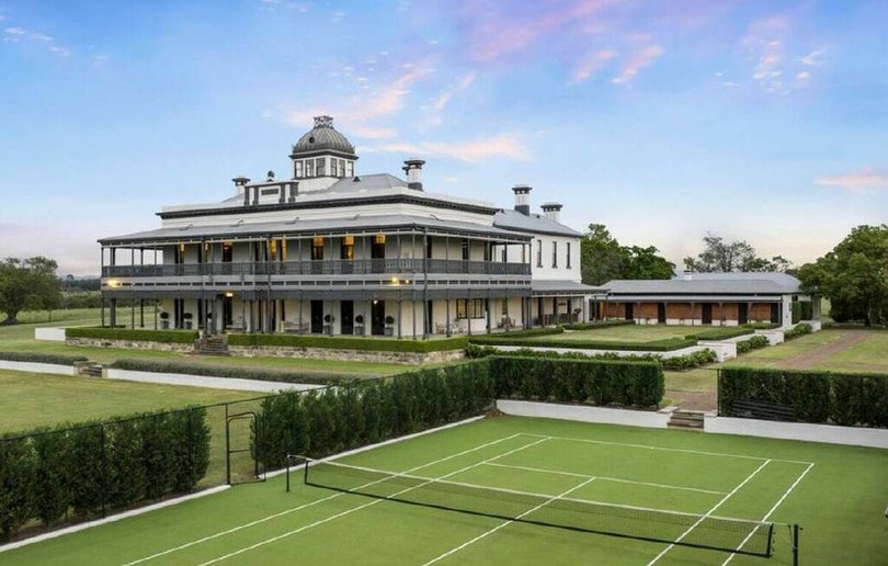 The grounds include a tennis court and landscaped gardens designed by Paul Bangay.