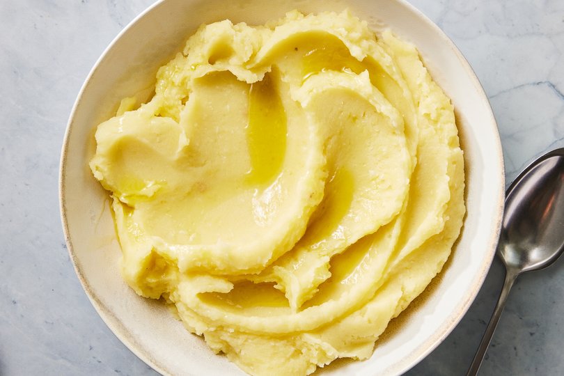 Olive oil mashed potatoes. Simmering whole garlic cloves with Yukon Golds gives these creamy, Thanksgiving-worthy potatoes a nice bite. Food styled by Rebecca Jurkevich. (Christopher Testani/The New York Times)