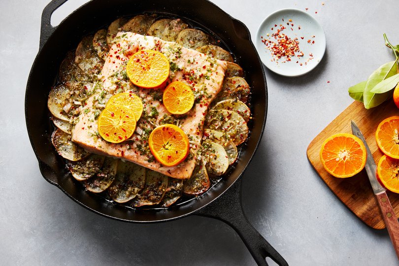 Citrusy roasted salmon and potatoes. Roasting a whole slab of salmon over thinly sliced Yukon Golds enriches the citrus-sauced spuds. Food styled by Monica Pierini. (Bobbi Lin/The New York Times)