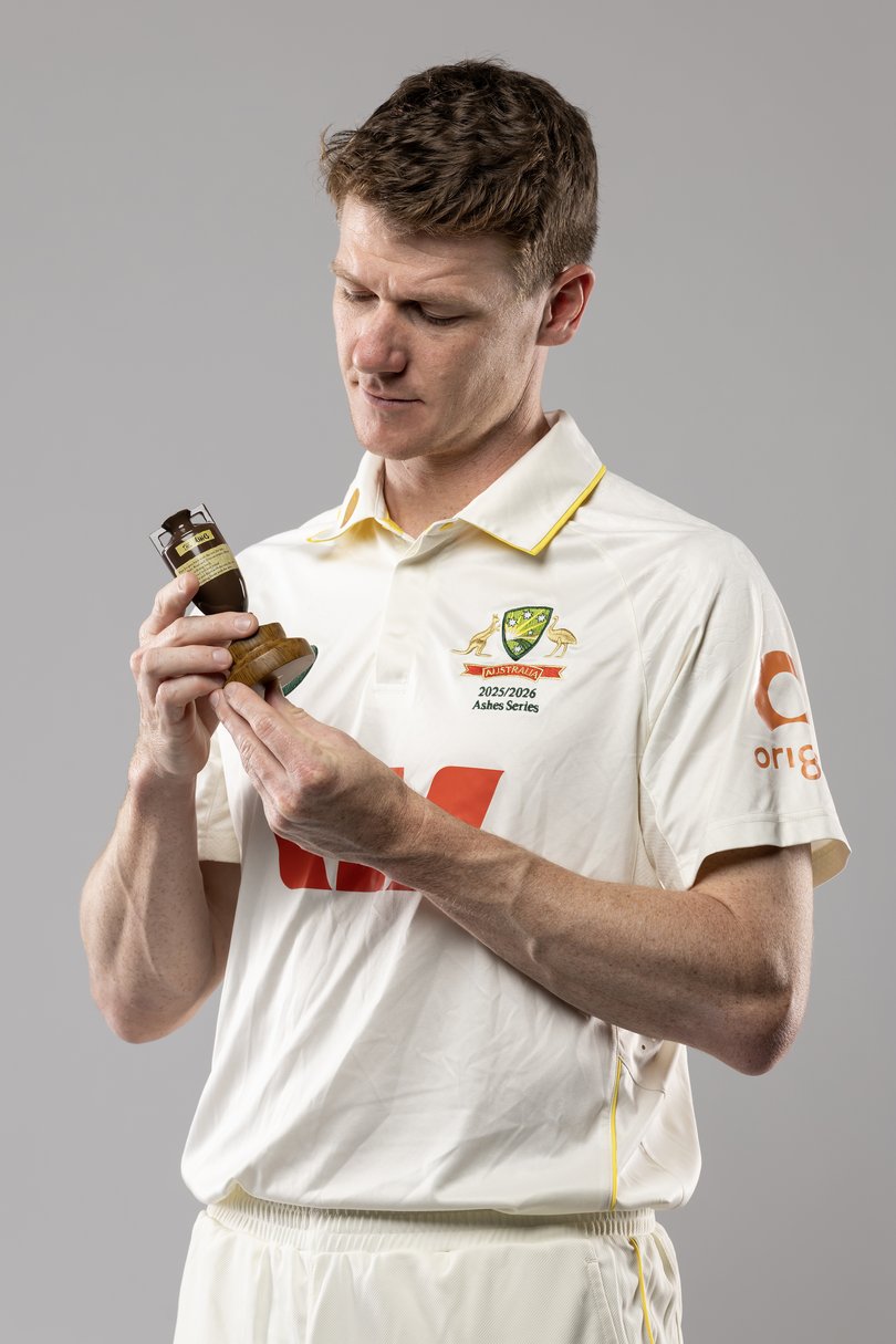 Brendan Doggett poses with an Ashes urn.