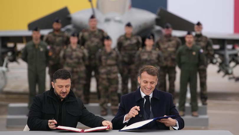The presidents of Ukraine and France signed a deal for Kyiv to purchase 100 French-made warplanes. (AP PHOTO)