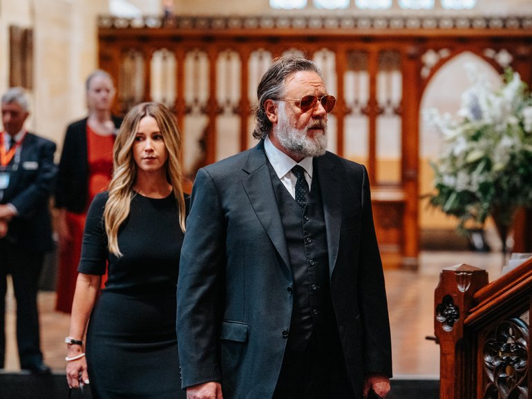 Britney Theriot and Russell Crowe attend a state funeral for John Laws at St. Andrew's Cathedral.
