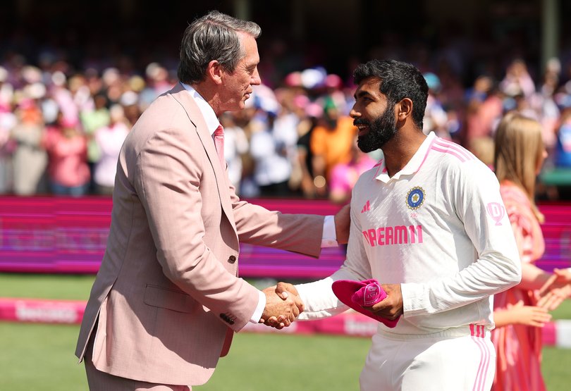 SYDNEY, AUSTRALIA - JANUARY 05: Jasprit Bumrah of India hands Glenn McGrath his pink cap prior to day three of the Fifth Men's Test Match in the series between Australia and India at Sydney Cricket Ground on January 05, 2025 in Sydney, Australia. (Photo by Cameron Spencer/Getty Images)