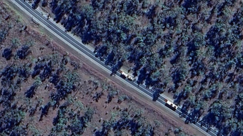 A woman and child have died after two trucks collided on a major Queensland highway.