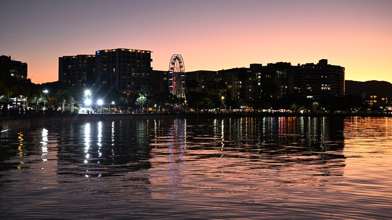 Buildings are seen on the Cairns Esplanade as the sunsets over Cairns in Queensland, Sunday, August 17, 2025. (AAP Image/Darren England) NO ARCHIVING