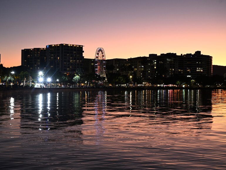 Buildings are seen on the Cairns Esplanade as the sunsets over Cairns in Queensland, Sunday, August 17, 2025. (AAP Image/Darren England) NO ARCHIVING