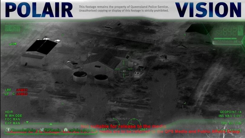 Gareth and Stacy sit at the table outside their home after killing the two police officers and their neighbour. Nathaniel Train is lying nearby beside them. Picture: QPS