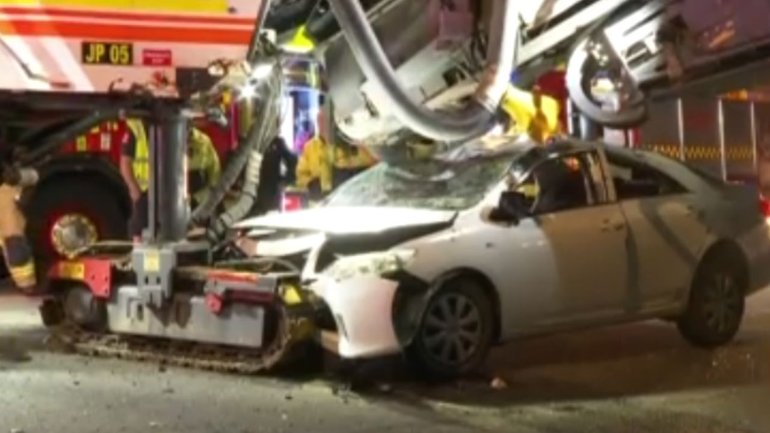 A 24-year-old driver has survived after becoming trapped under a roadworks machine during a crash in Blacktown.