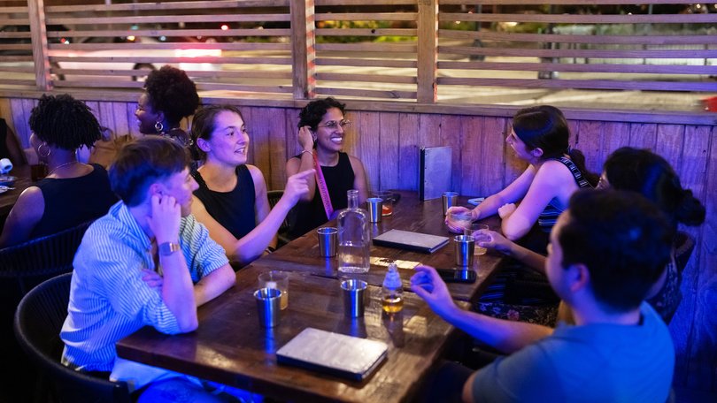 A group of friends have drinks outside Service Bar in Washington. 