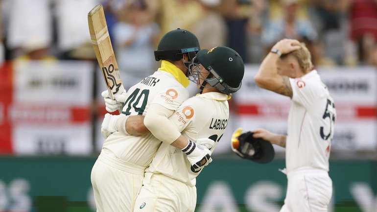 Steve Smith and Marnus Labuschagne celebrate Australia’s win as Ben Stokes looks on.