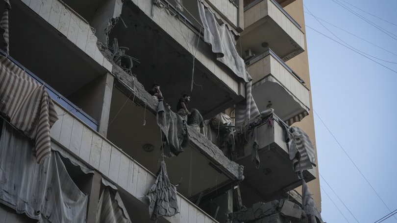 Men stand in the apartment attacked by the Israeli military on November 23, 2025 in Beirut, Lebanon.