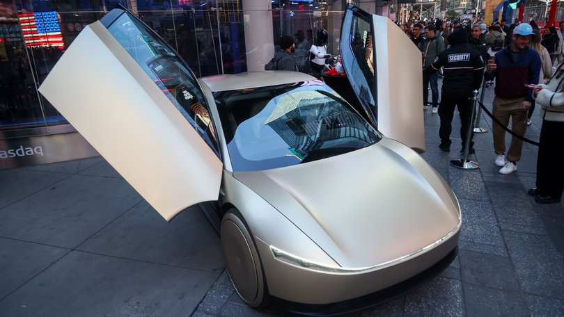 A Tesla Optimus robot and Cybercab prototype in front of the Nasdaq MarketSite in New York last month. 