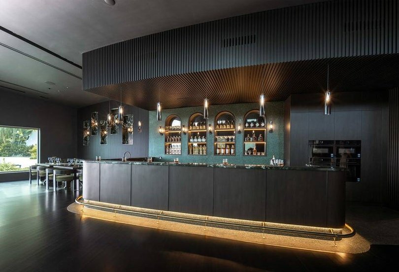 The home's whisky bar has marble and bronze finishes.