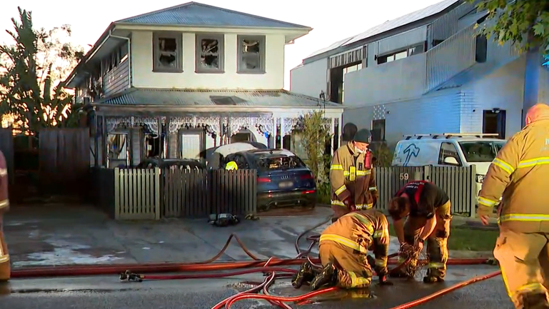 Firefighters tackle a suspected firebombing of a Melbourne home.