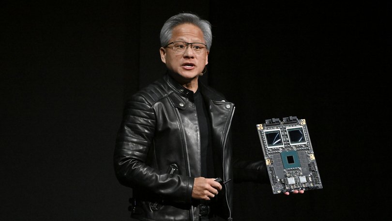 Jensen Huang holds a display of Nvidia's AI accelerator chip. 