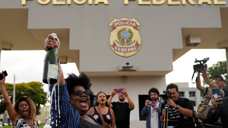 Detractors of former President Jair Bolsonaro celebrate his sentence for leading a coup attempt, outside the federal police headquarters, where he is under arrest in Brasilia.