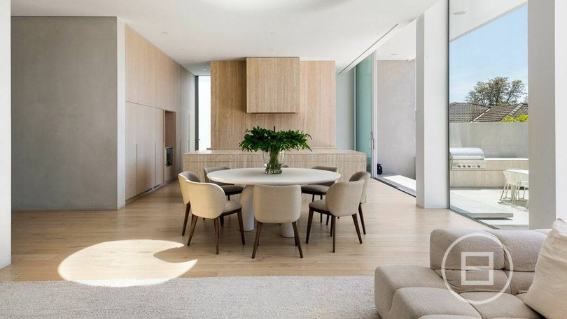 A butler's pantry is concealed behind the kitchen.