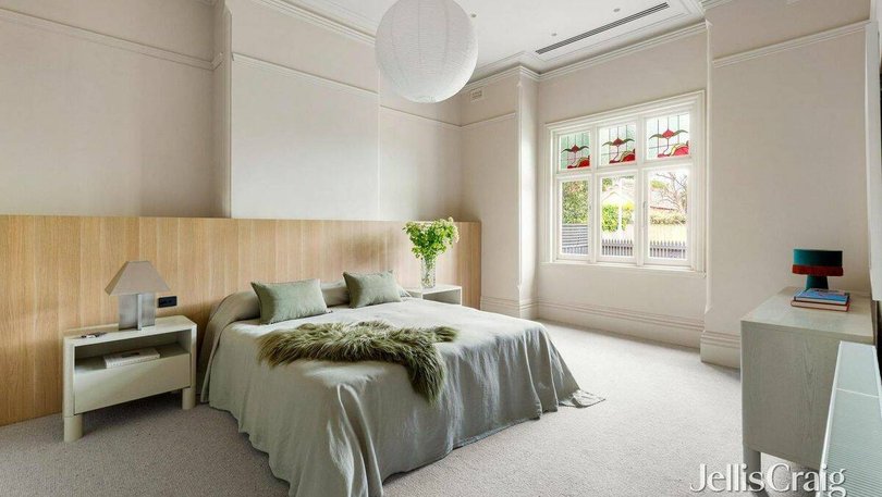 The master suite features a built-in decorative timber bedhead, walk-in-robe and ensuite.